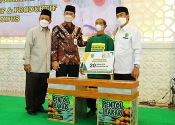 MENYERAHKAN: Bupati Kudus HM Hartopo saat menyerahkan bantuan kepada kaum dhuafa di Gedung JHK Kudus, Selasa (15/2). ( Istimewa I Harianmuria.com )