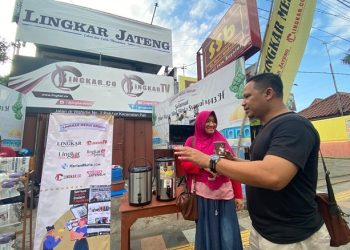 HARMONIS: Komisaris Utama Lingkar Media Group, Agus Sunarko bersama istri tercinta menikmati secangkir kopi khas Pati di stan Lingkar Media Group saat CFD, Minggu (3/7). ( Lingkar Media Group I Harianmuria.com )
