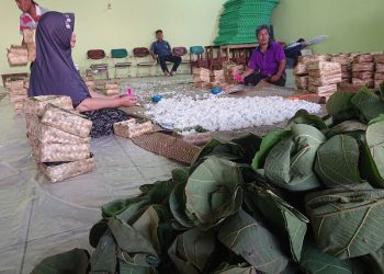 PENGEMASAN NASI: Panitia Buka Luwur Mbah Panggung Langgardalem Kudus saat mengemas nasi jangkrik dan nasi uyah asem.(Hasyim Asnawi/Harianmuria.com)