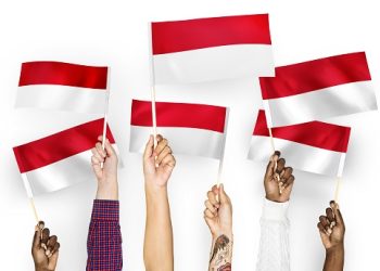 Hands waving flags of Indonesia