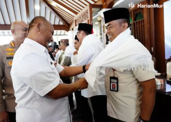 Kepala Satpol PP Sugiyono (kanan) saat dipasangkan ihram oleh Pj Bupati Pati pada acara manasik haji beberapa waktu lalu. (Istimewa/Harianmuria.com)