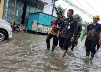 Bupati Kudus Sam'ani Intakoris meninjau banjir di Desa Kesambi, Kecamatan Mejobo. (Fahtur Rohman/Harianmuria.com)