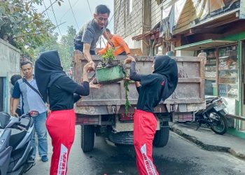 Dua orang pelajar mengangkat sampah ke atas truk saat Resik-Resik Kutho yang digelar Pemkot Salatiga di lingkungan Kalioso, Jumat, 13 Juni 2025. (Dok. Setda Salatiga/Harianmuria.com)